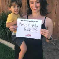 CFA member Alma Itzé Flores holds her baby and a sign reading "CFA is bargaining for parental leave."