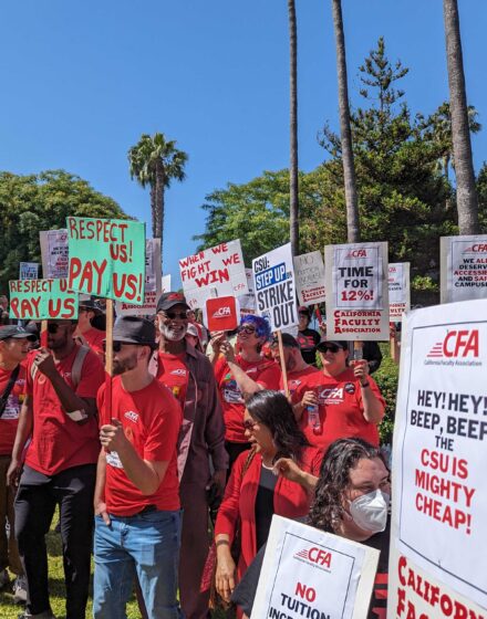 CFA members holding picket signs rally against tuition increases.