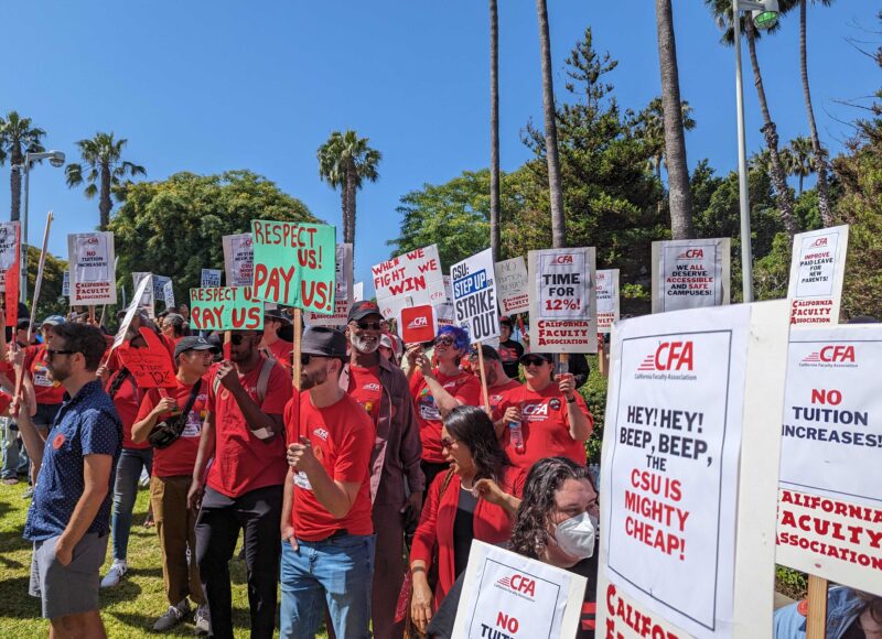 CFA members holding picket signs rally against tuition increases.