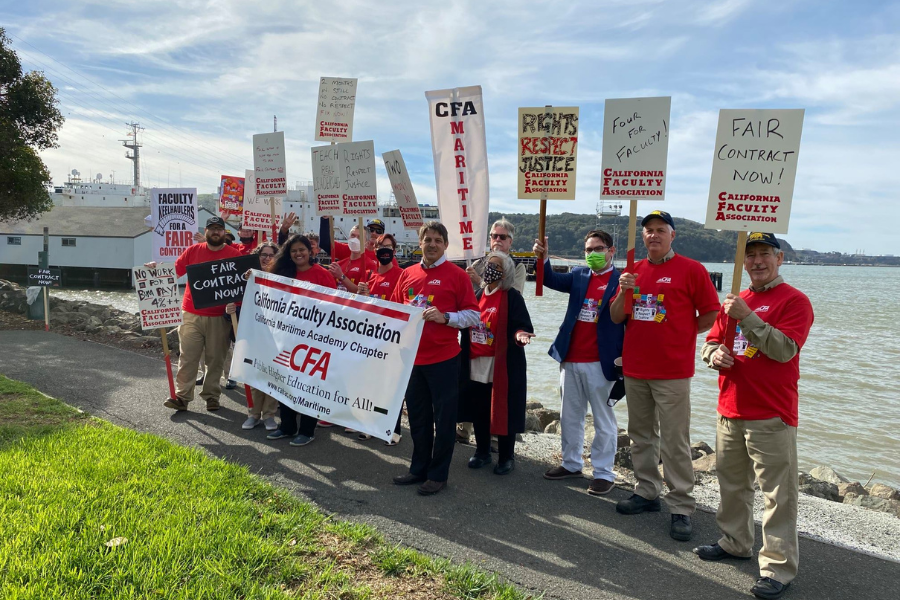 A group of Maritime Chapter members with signs outdoors.