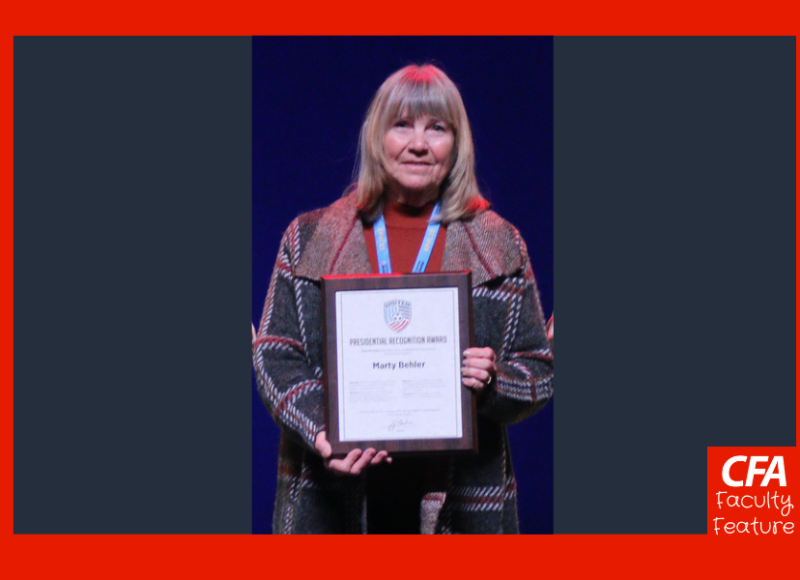 Woman holding an award.