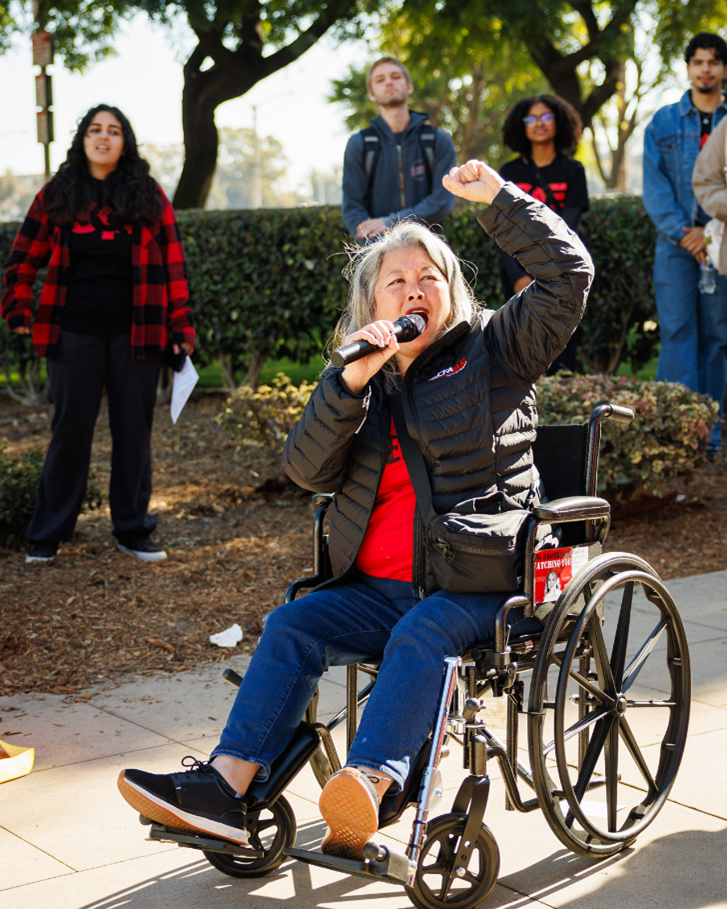 A person in a wheelchair holding a microphone